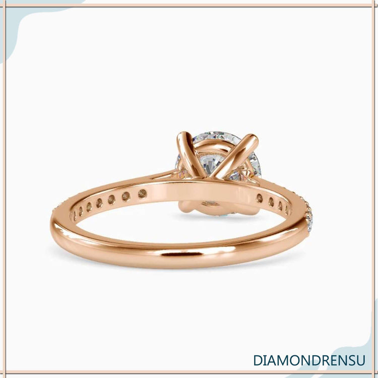 Custom engagement ring featuring pave band and round diamond.