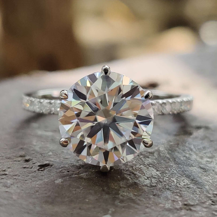 Round cut moissanite engagement ring with hidden halo.