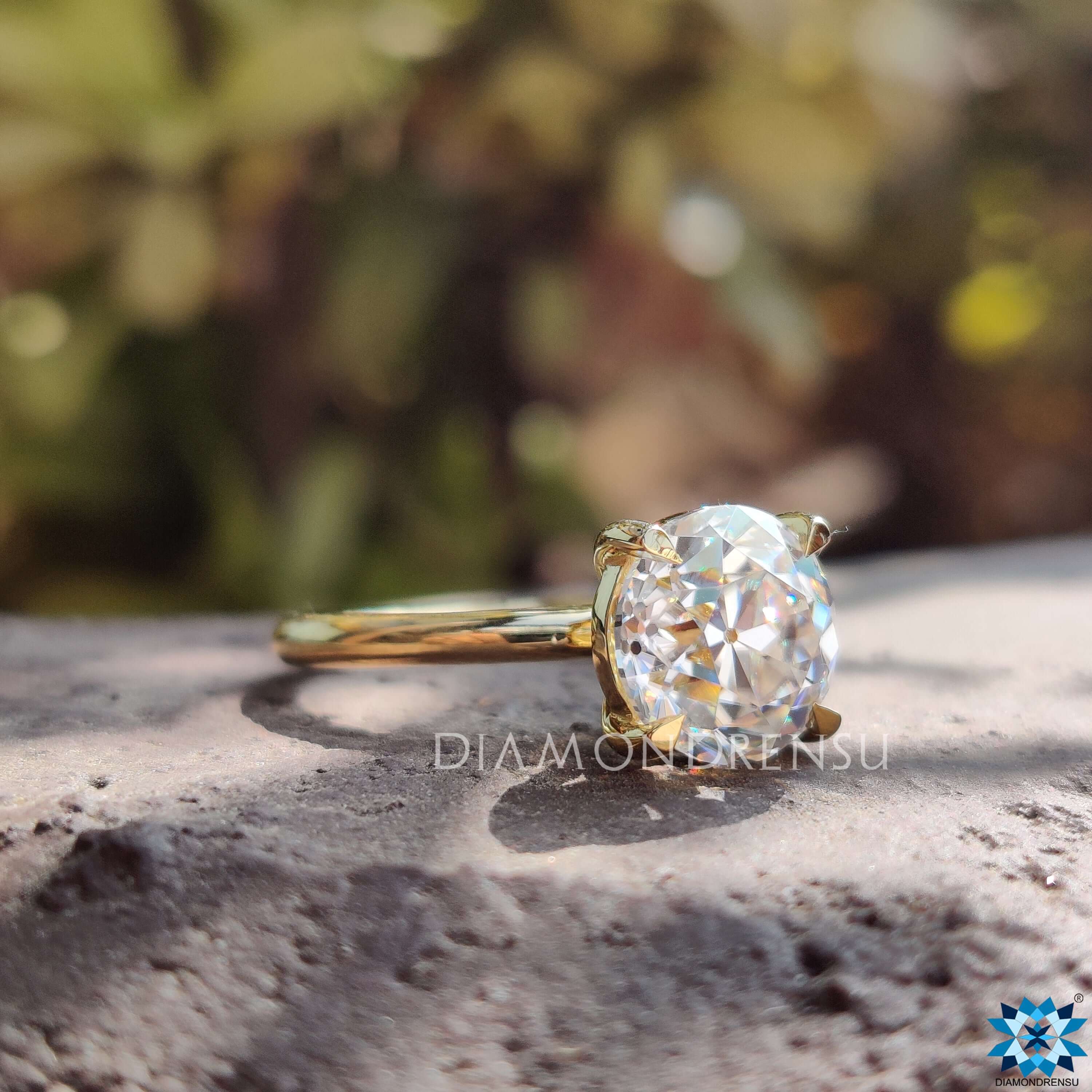Yellow gold ring featuring round cut moissanite center stone.
