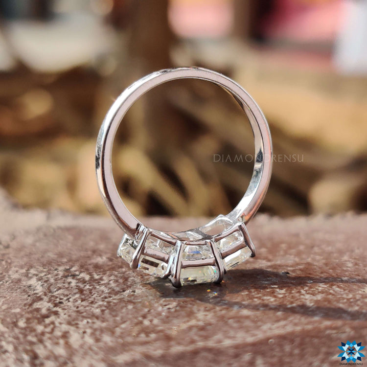 Three stone emerald moissanite engagement ring.