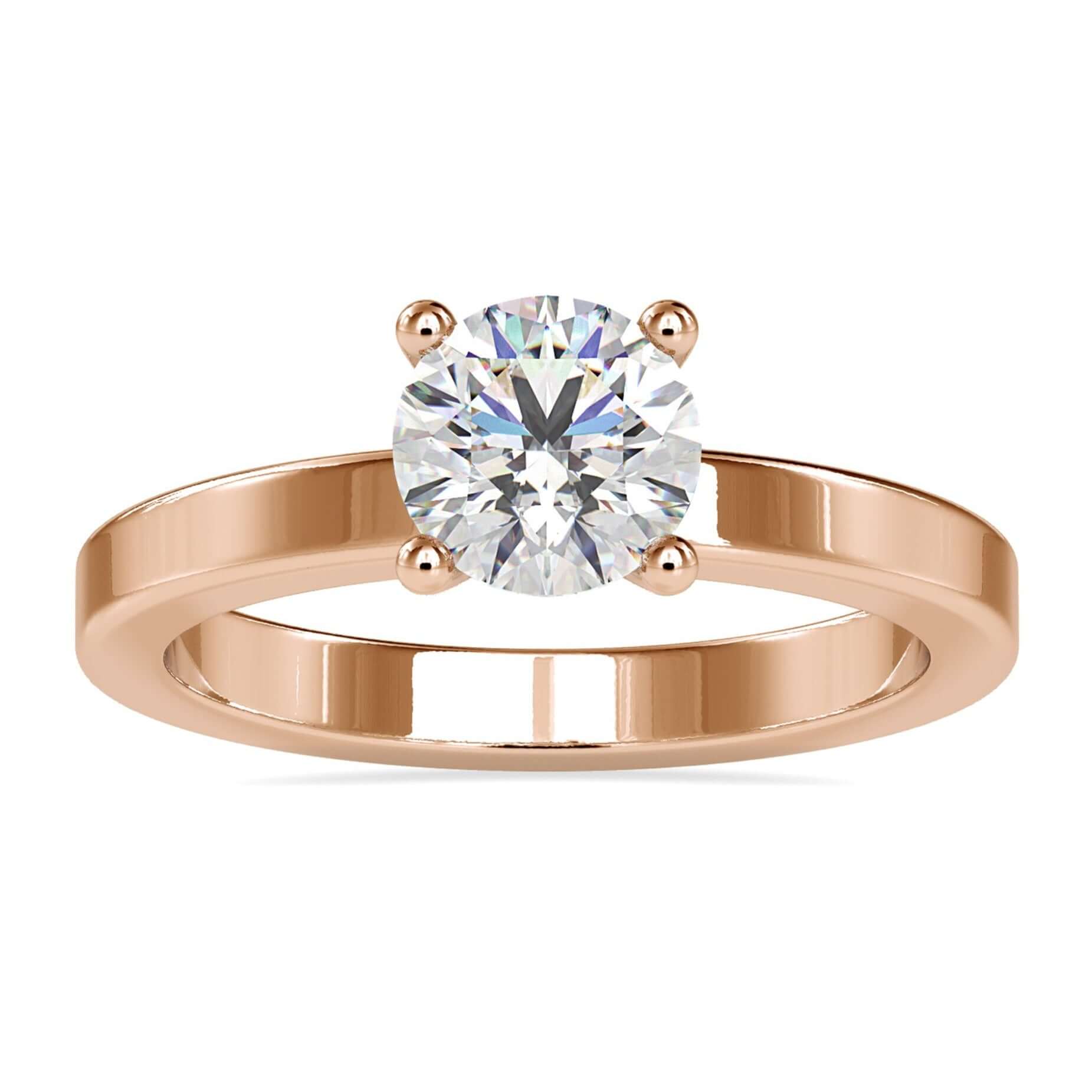 Gold diamond solitaire engagement ring with round prong setting.