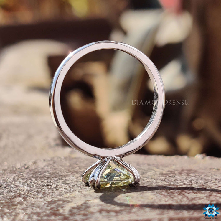 Solitaire setting ring with radiant cut moissanite.