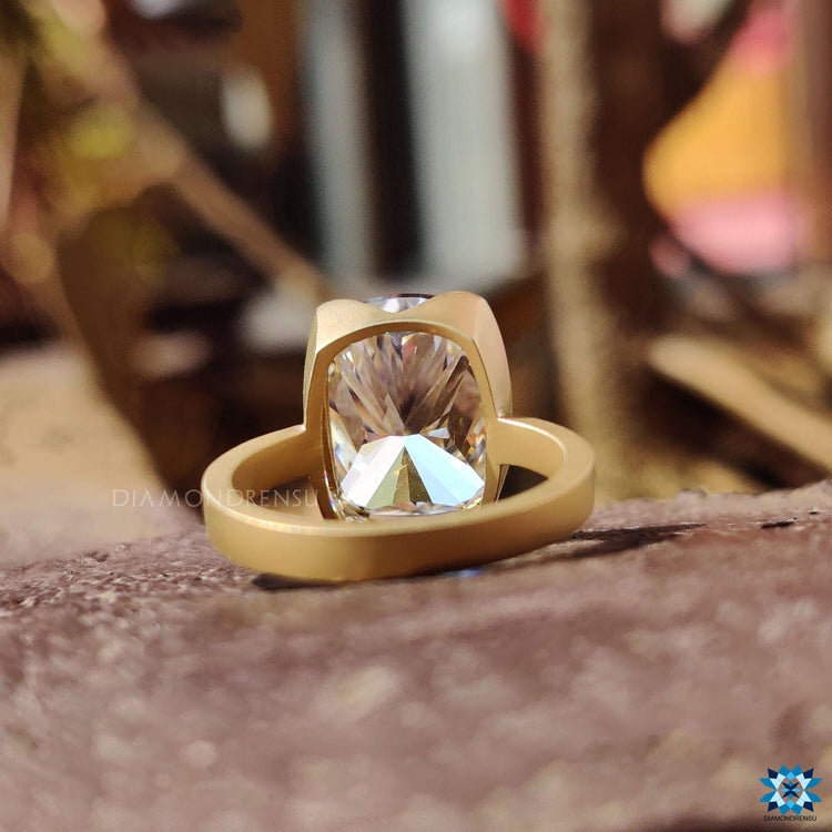 Handmade moissanite ring with cushion cut center stone.