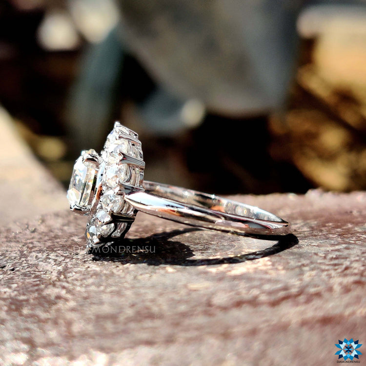 White gold cluster engagement ring with bezel set stones.
