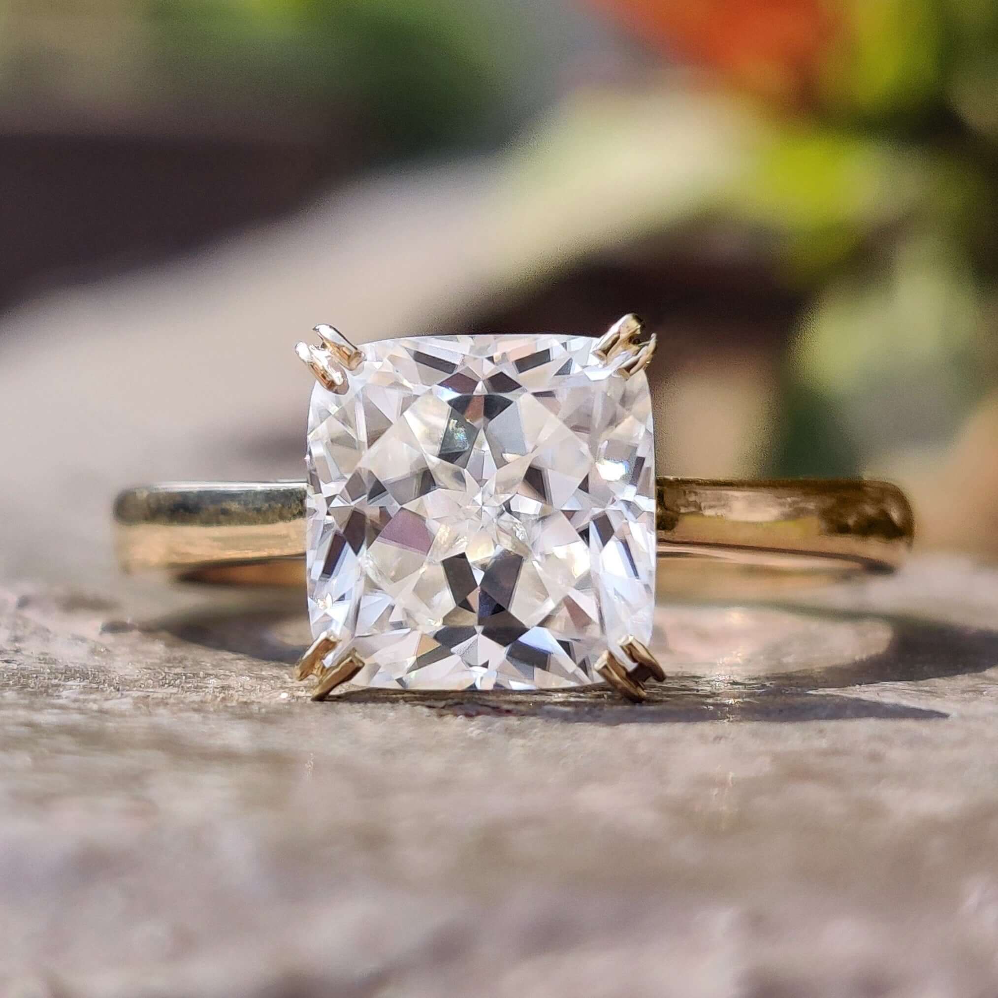 Cushion Rensu moissanite ring in yellow gold.