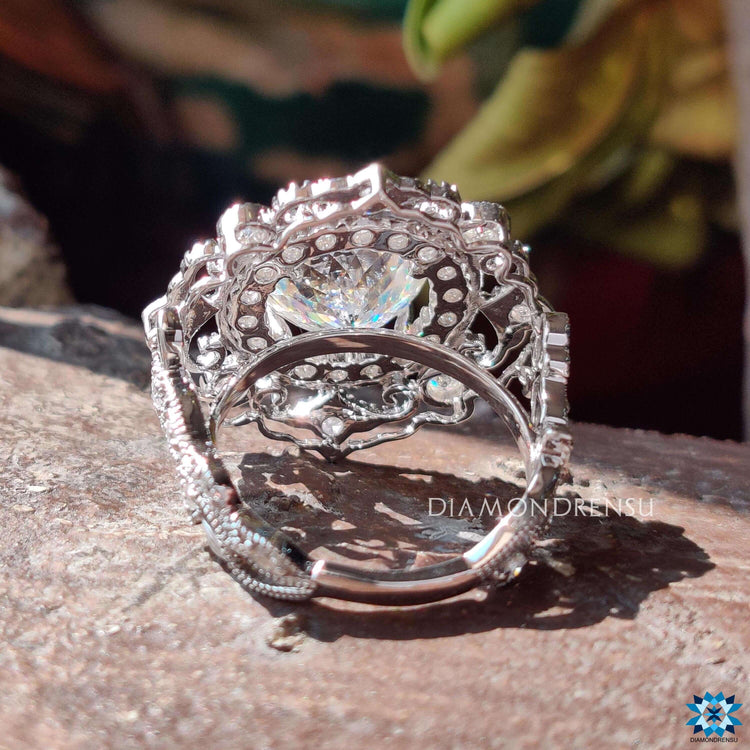 White gold moissanite ring with vintage filigree and prong setting.