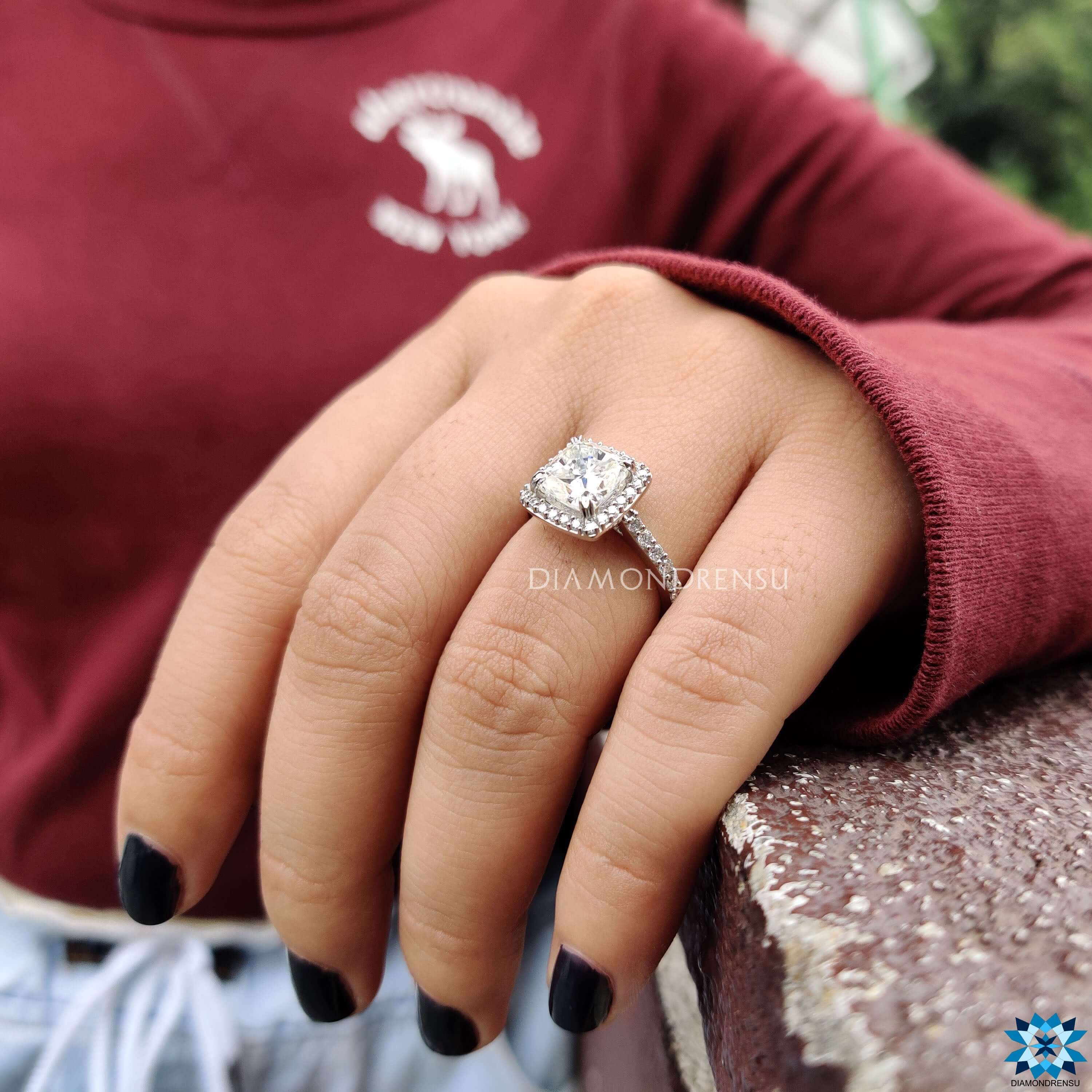 Custom engagement ring with cushion moissanite and pavé band.
