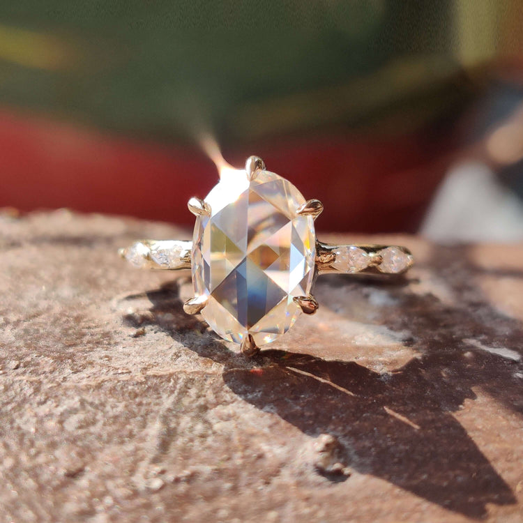 Oval rose cut moissanite engagement ring in yellow gold.