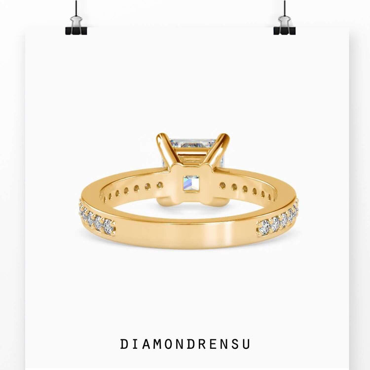 Yellow gold engagement ring with pave diamond accents.