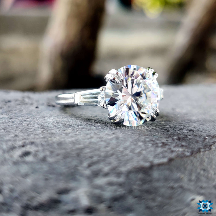White gold engagement ring with three moissanite stones.