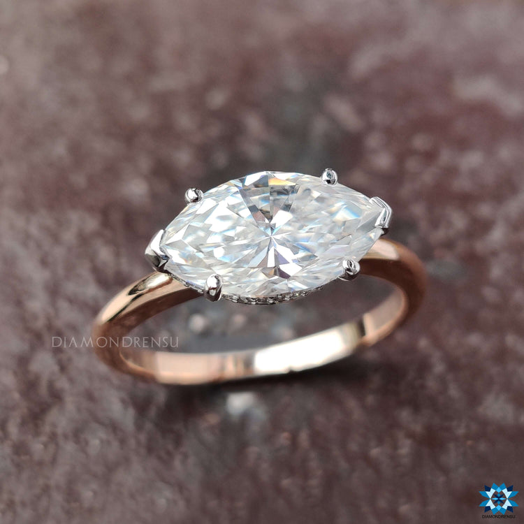 Two-tone engagement ring with marquise center and V prongs.
