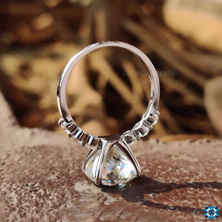 Handmade moissanite engagement ring with pave setting and Portuguese cut center.