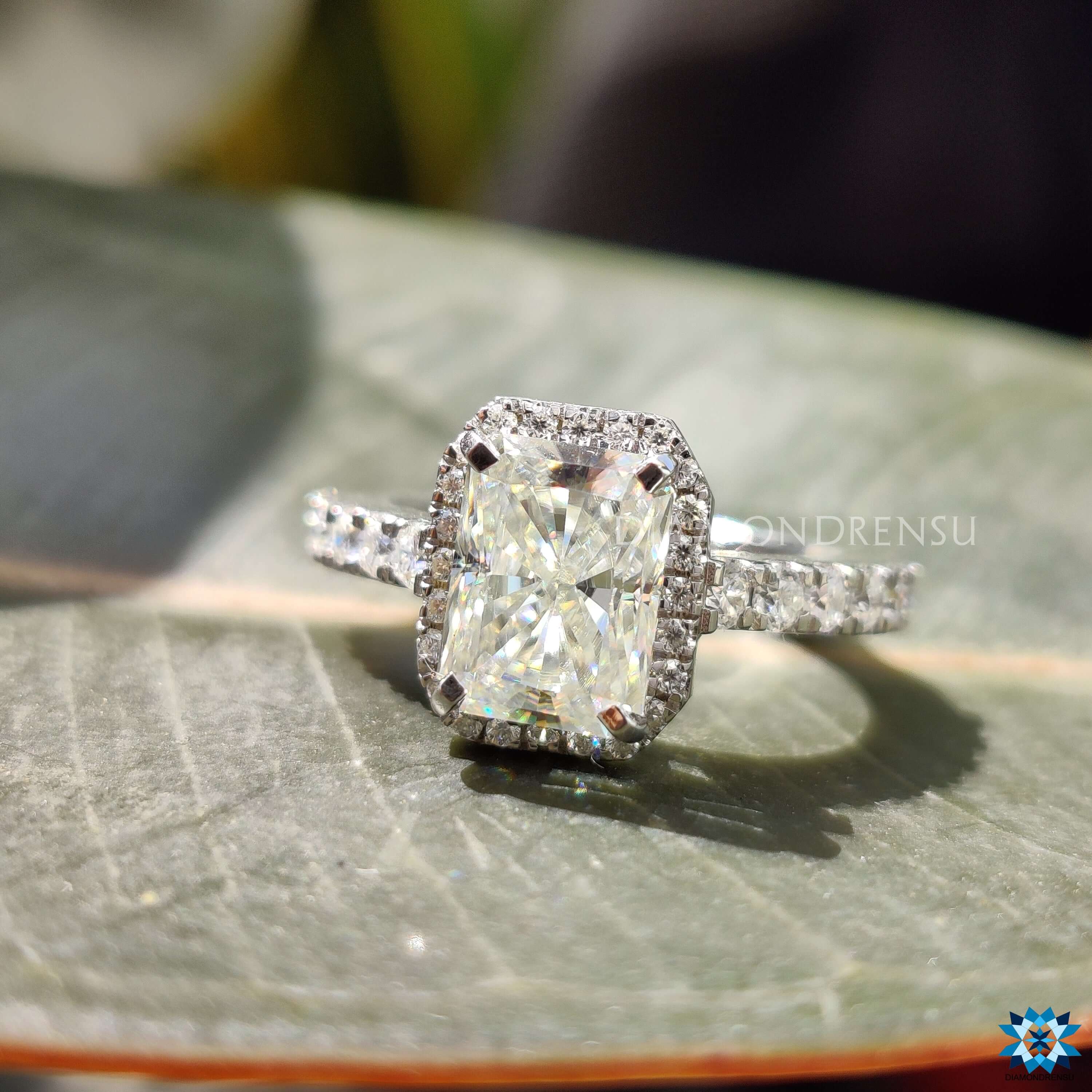White gold engagement ring with radiant moissanite and hidden halo.