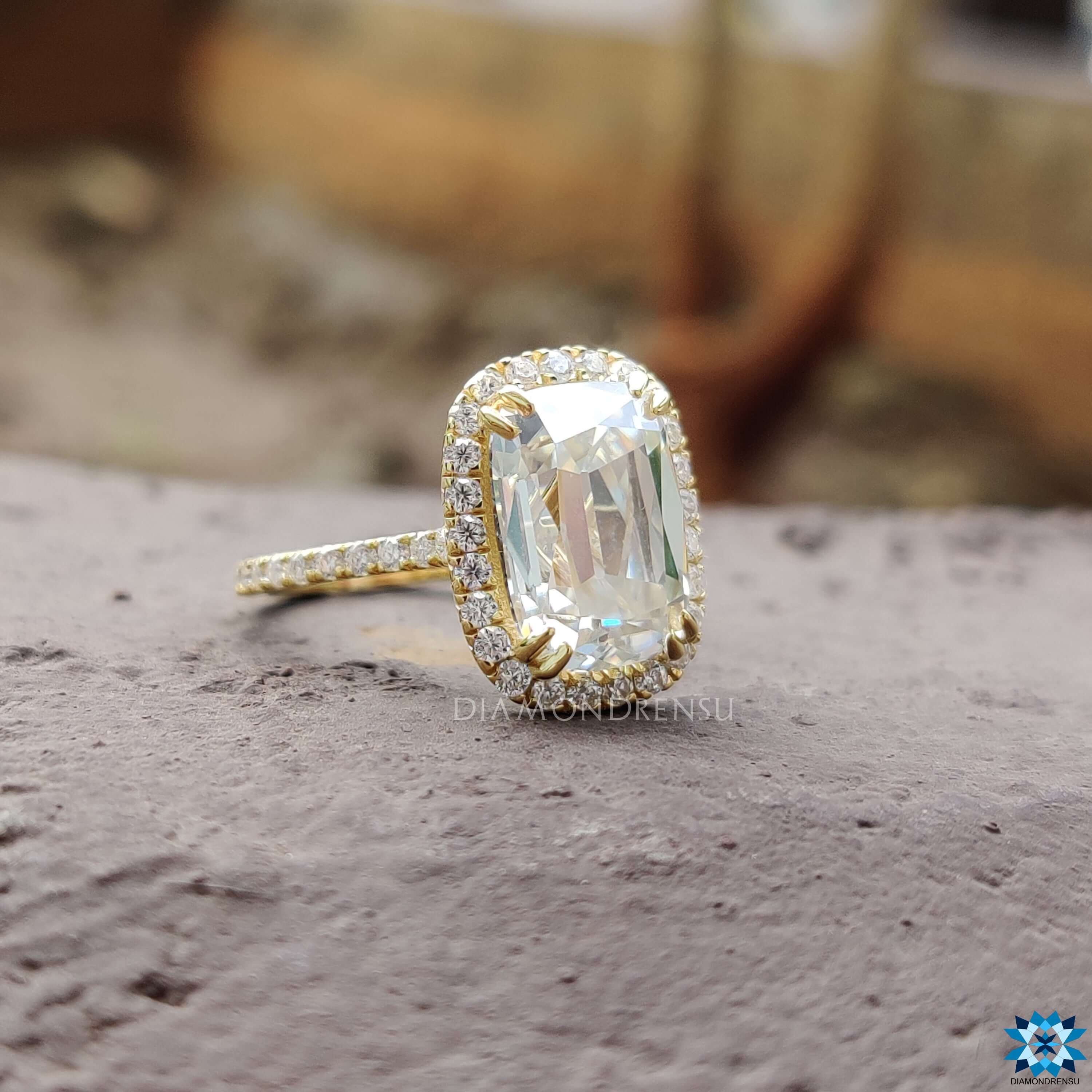Custom yellow gold engagement ring with cushion cut moissanite.