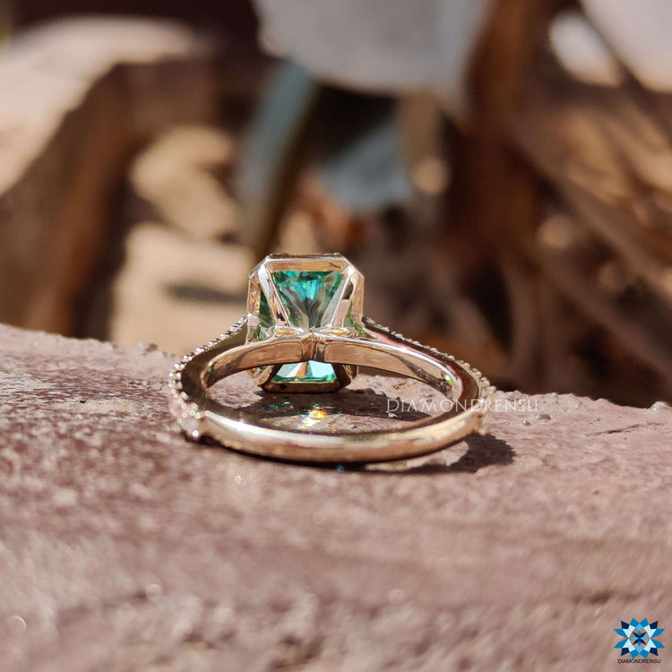 Vintage style engagement ring with green moissanite.