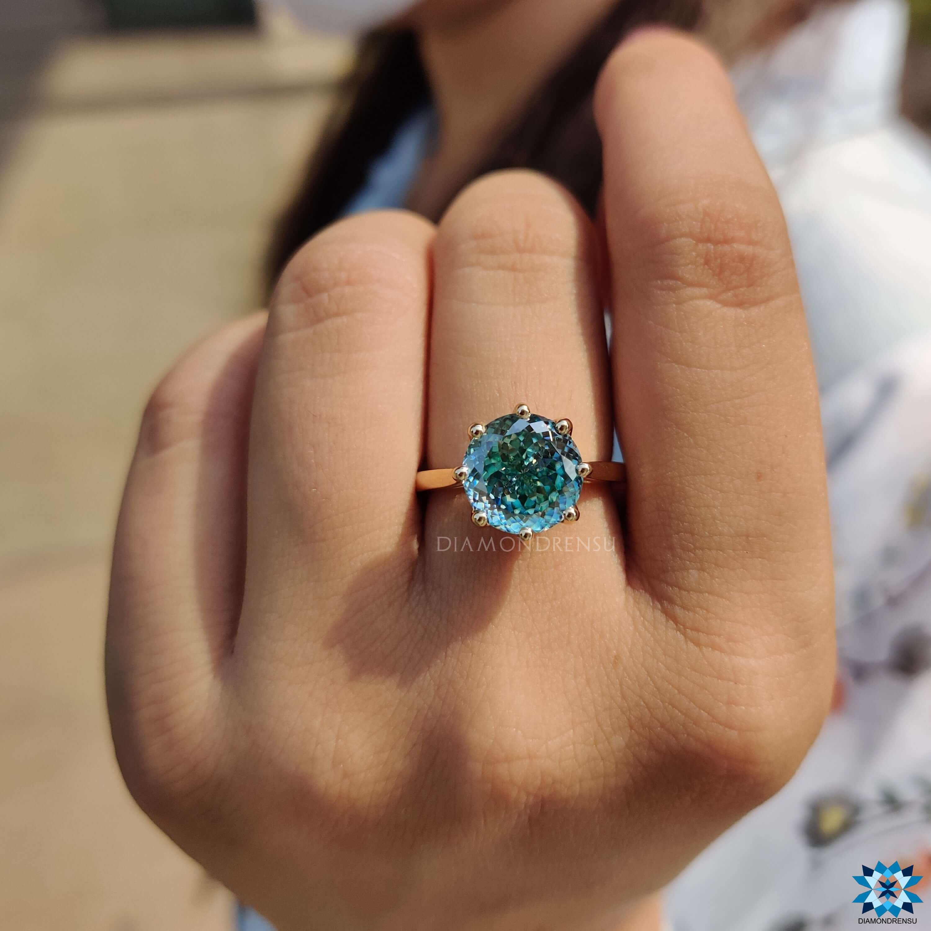 Yellow gold solitaire engagement ring with cathedral setting.
