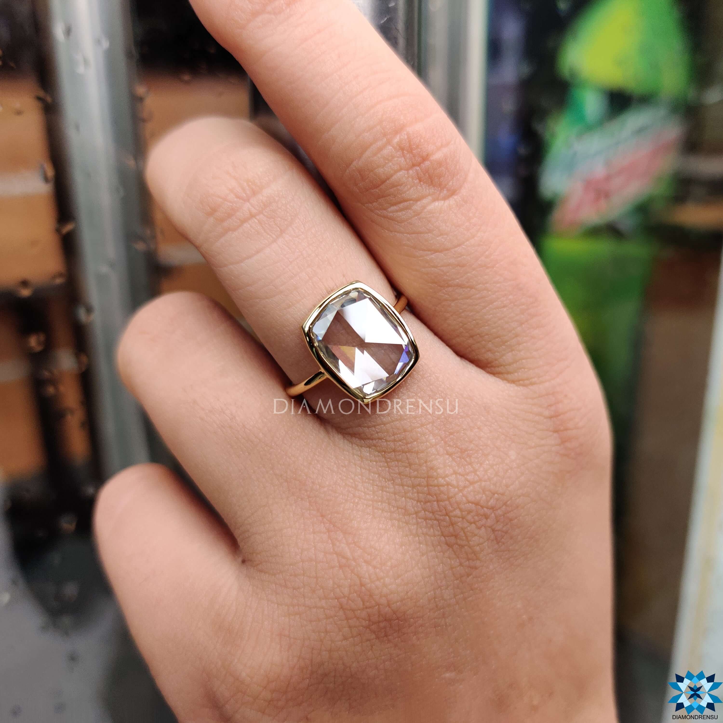 Bezel setting engagement ring with off-white moissanite.