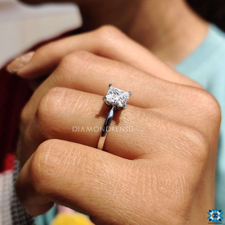 Princess cut moissanite ring with simple prong mount.