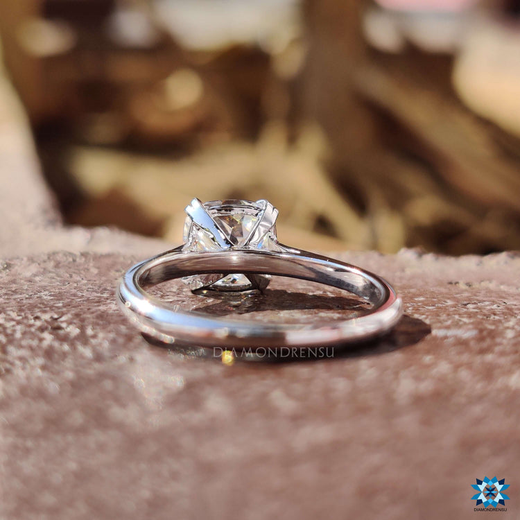 Custom moissanite engagement ring in a cathedral mount.