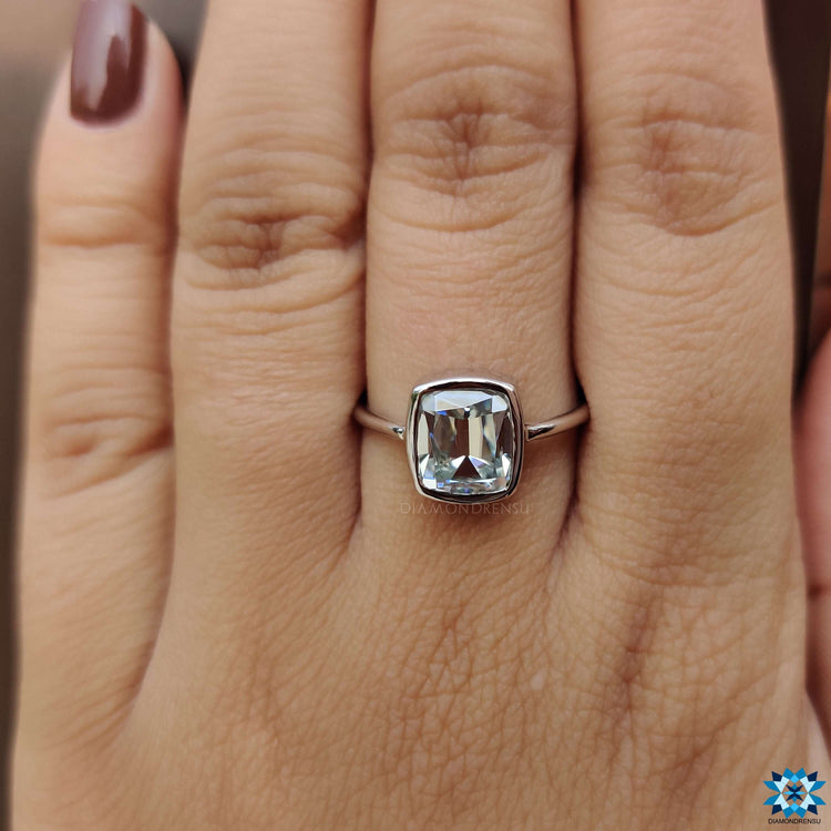 Cushion bezel set engagement ring with vintage-inspired cut.
