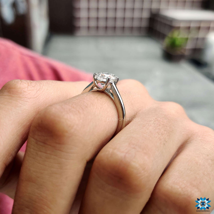 Elegant moissanite ring in white gold with claw prongs.