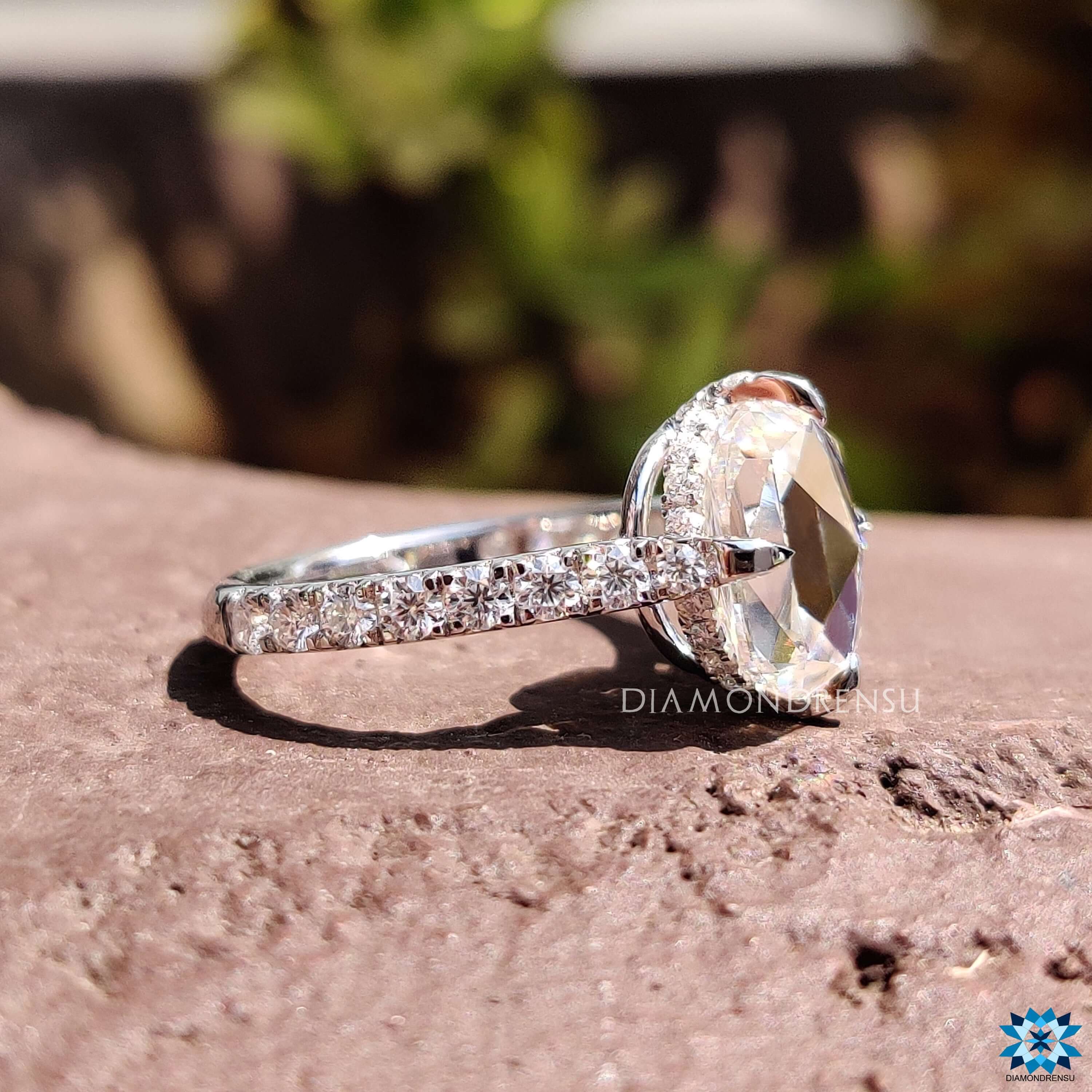 Hidden halo engagement ring with cushion moissanite.