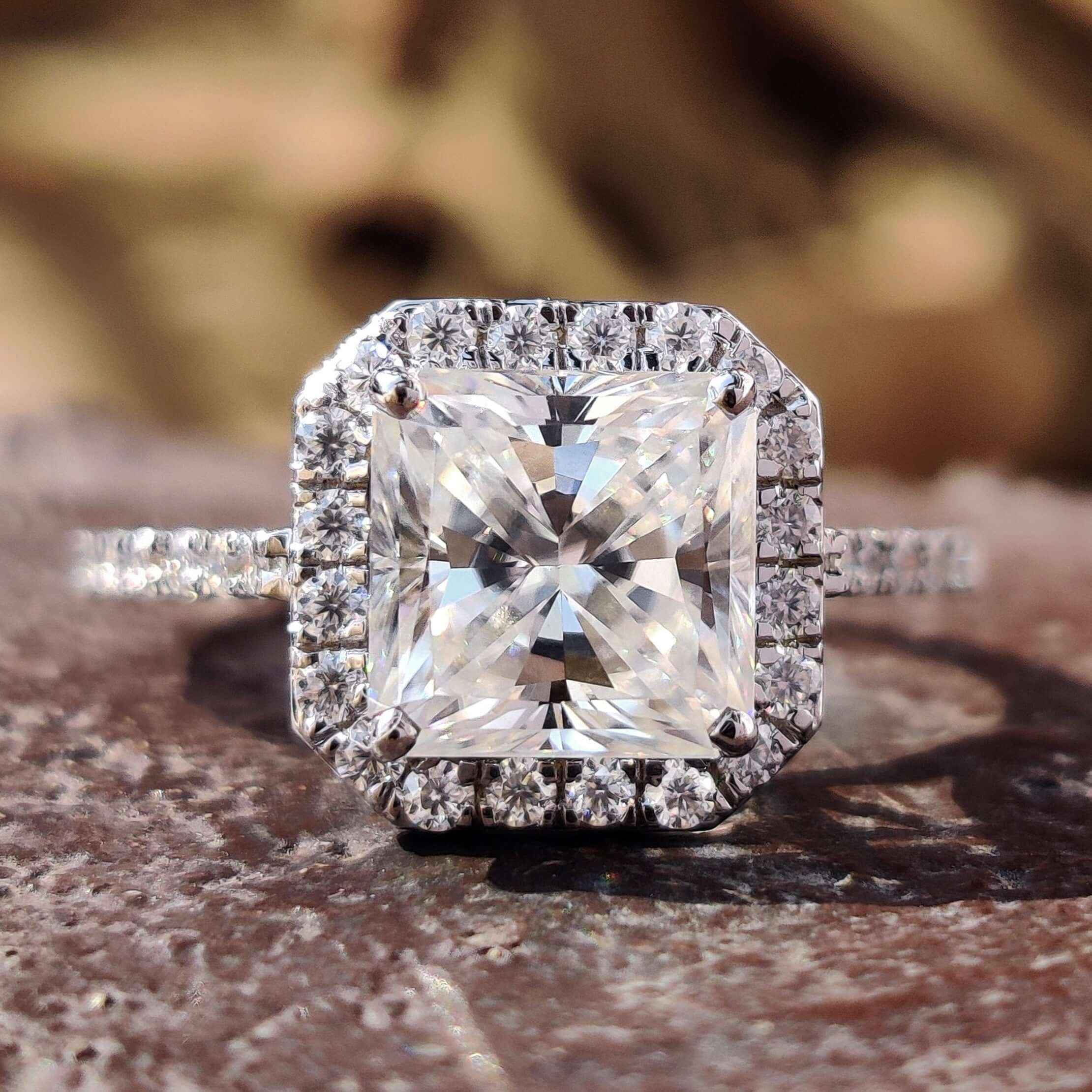 Halo engagement ring with radiant cut moissanite.