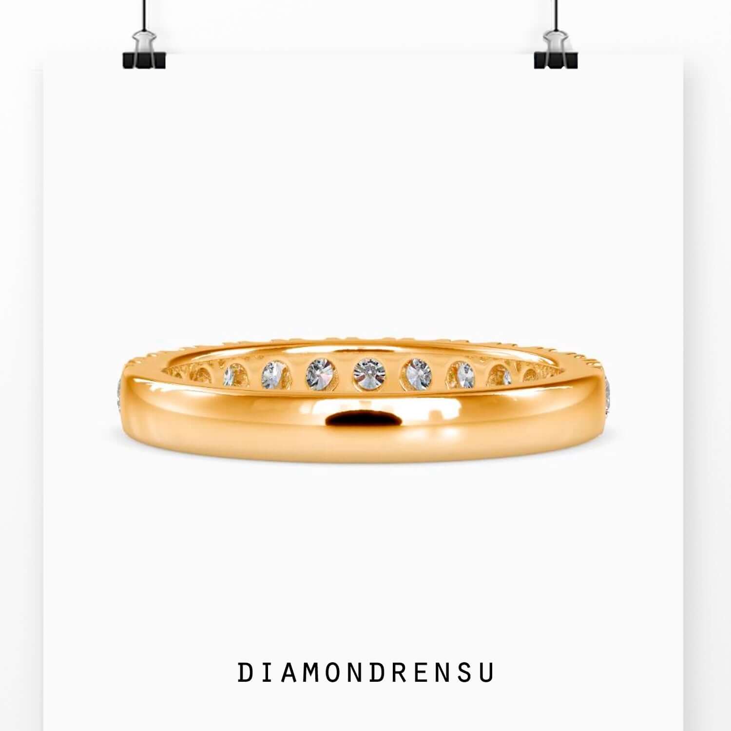 UK diamond wedding band with clean prong setting.