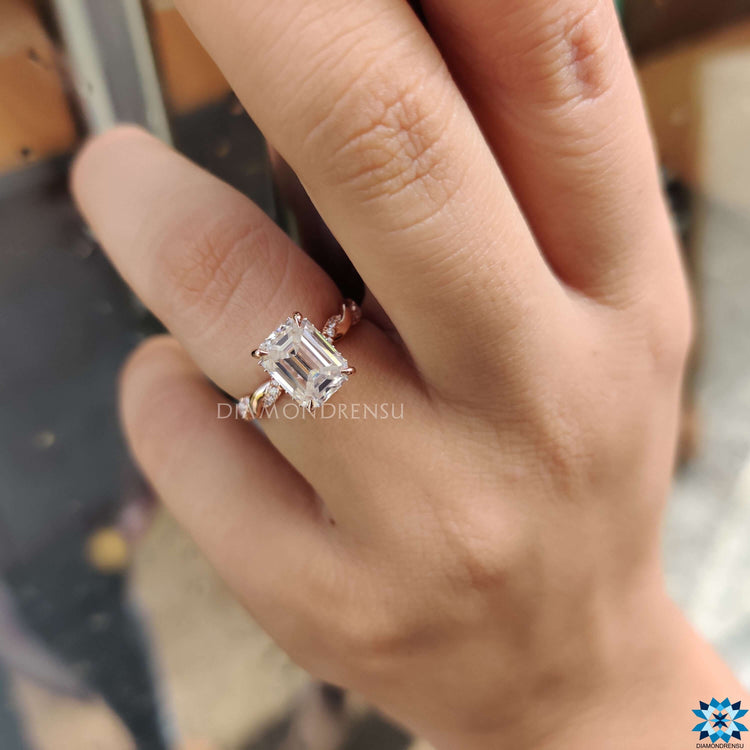 Emerald cut moissanite ring paired with twisted wedding band.