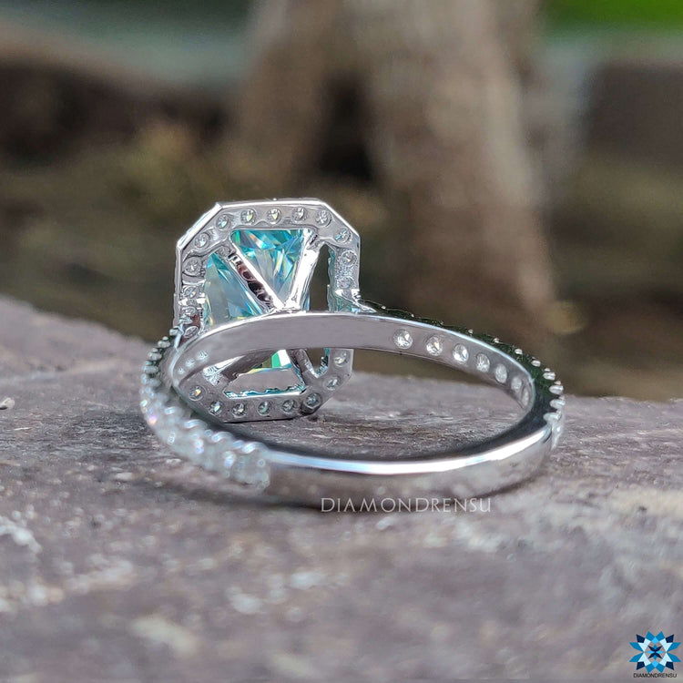 Handmade white gold ring with radiant cut blue moissanite.
