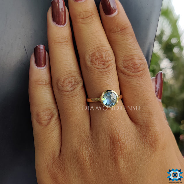 Bezel ring showcasing rose cut moissanite in solitaire engagement style.