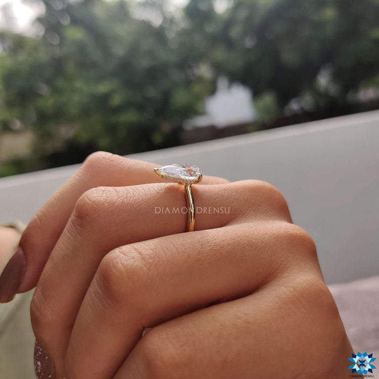 Yellow gold solitaire ring with hidden halo detail.