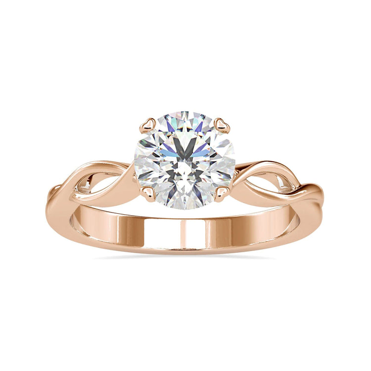 Twisted engagement ring with round cut diamond.