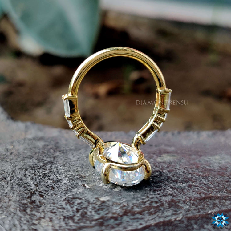 Four prong moval cut moissanite ring with pave accents.
