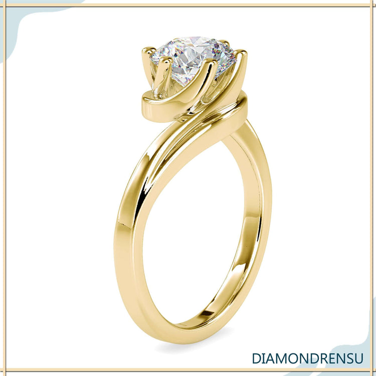 Round diamond solitaire ring with white gold bypass setting.