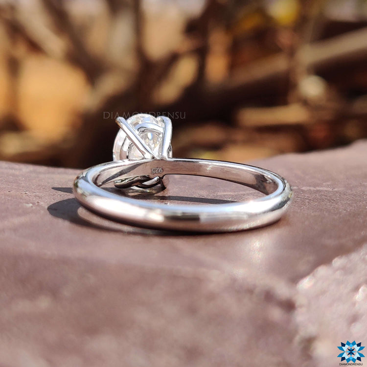 Oval moissanite engagement ring with 4 claw setting and custom finish.