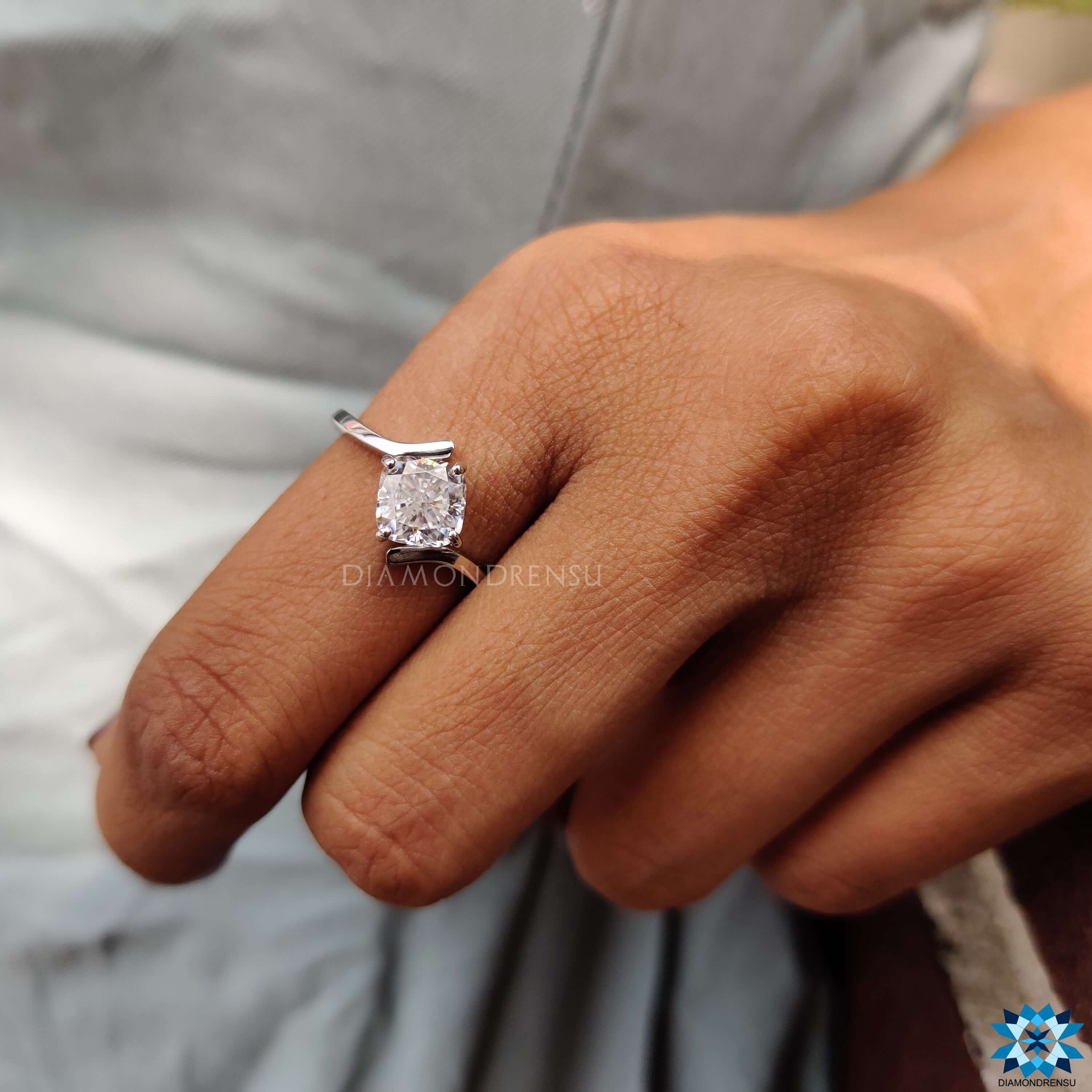 White gold handmade ring with four prong cushion moissanite.