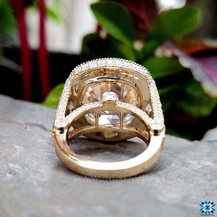 Cushion cut engagement ring with 4 prong setting in yellow gold.