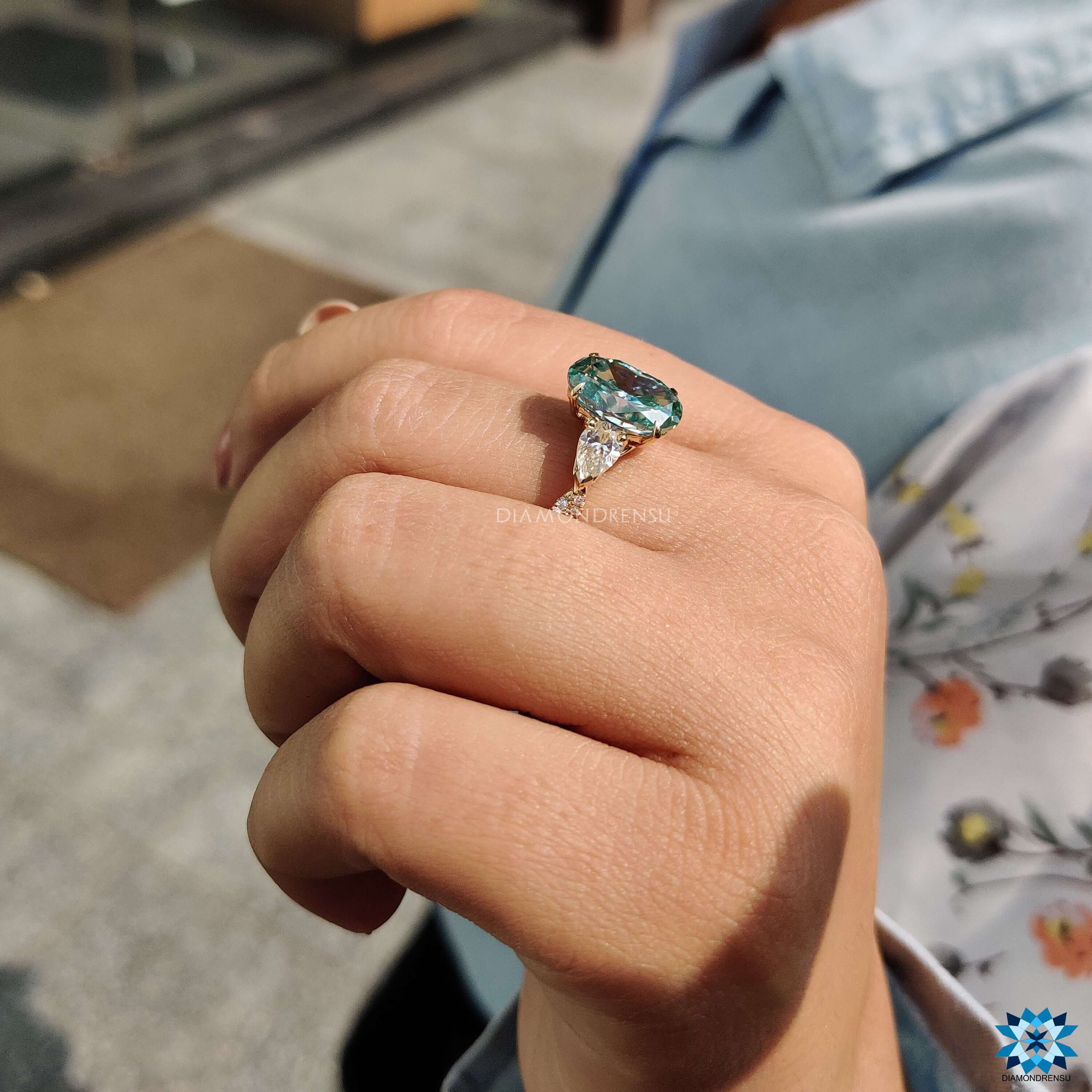 Moissanite engagement ring with a claw prong setting and twisted shank.