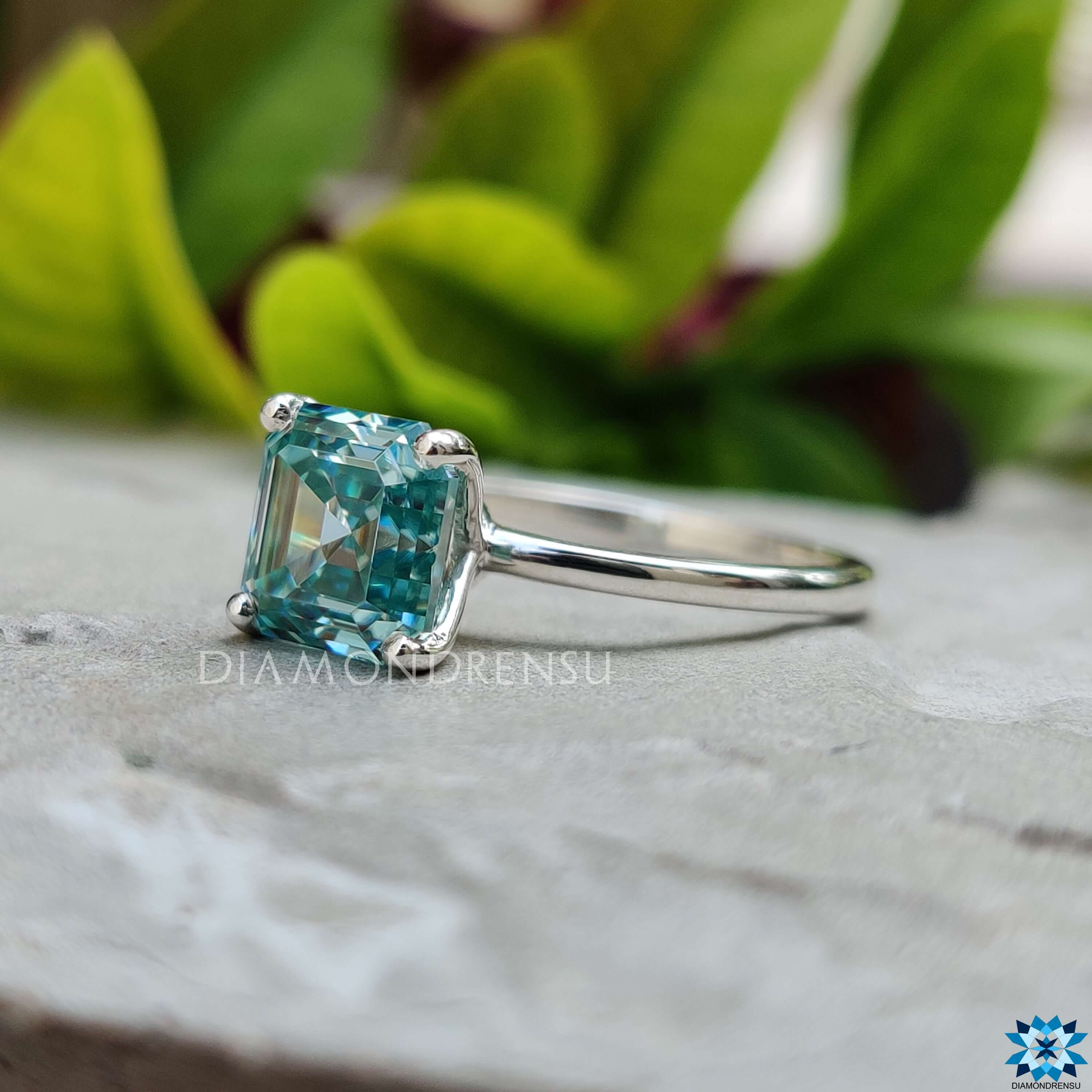 Four prong Asscher cut moissanite ring in white gold.