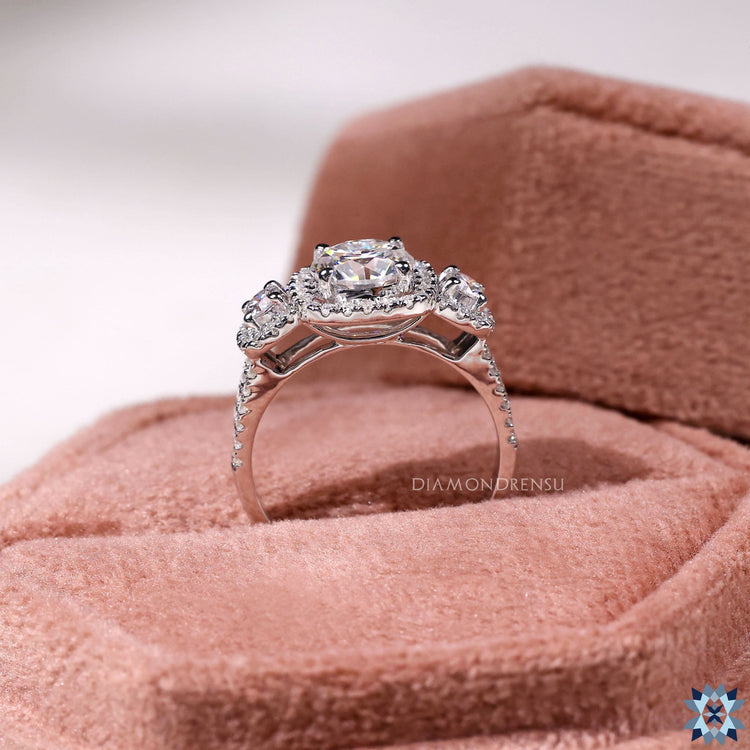 Round cut pave band on three stone engagement ring.