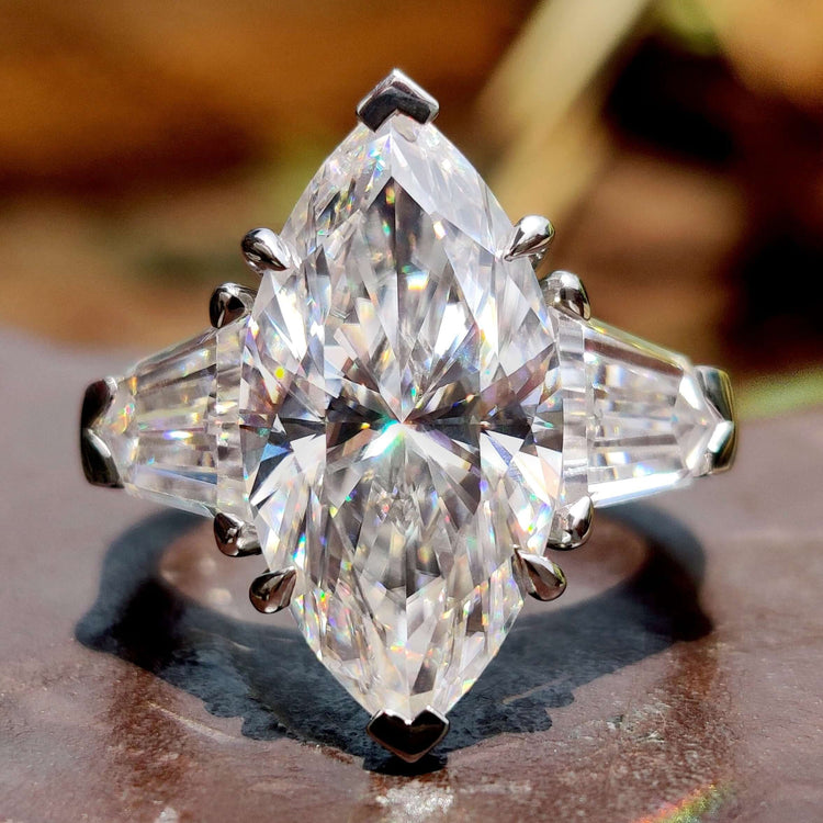 Three stone engagement ring with marquise cut center and bullet side stones.