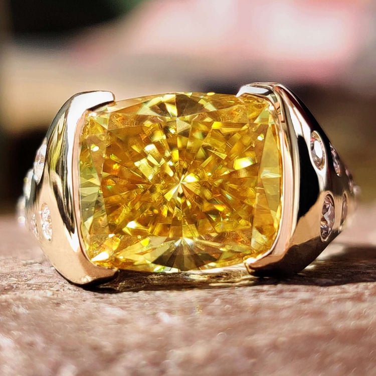 Cushion cut canary yellow moissanite engagement ring in yellow gold.