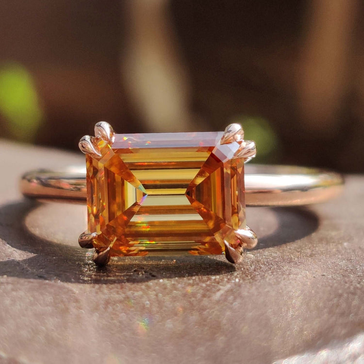 Emerald cut champagne moissanite ring.