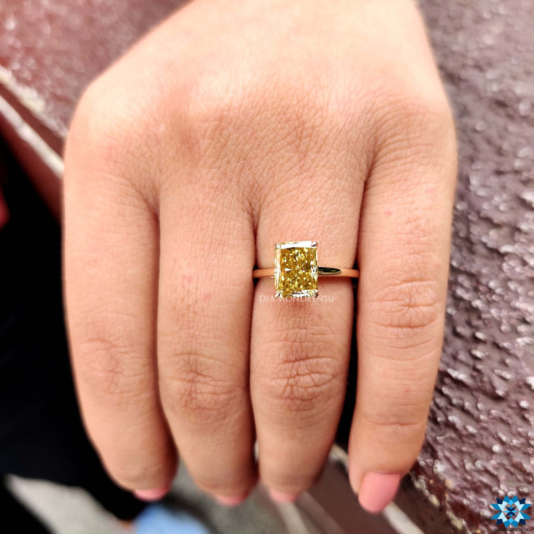 Custom moissanite ring with radiant center and prong mount.