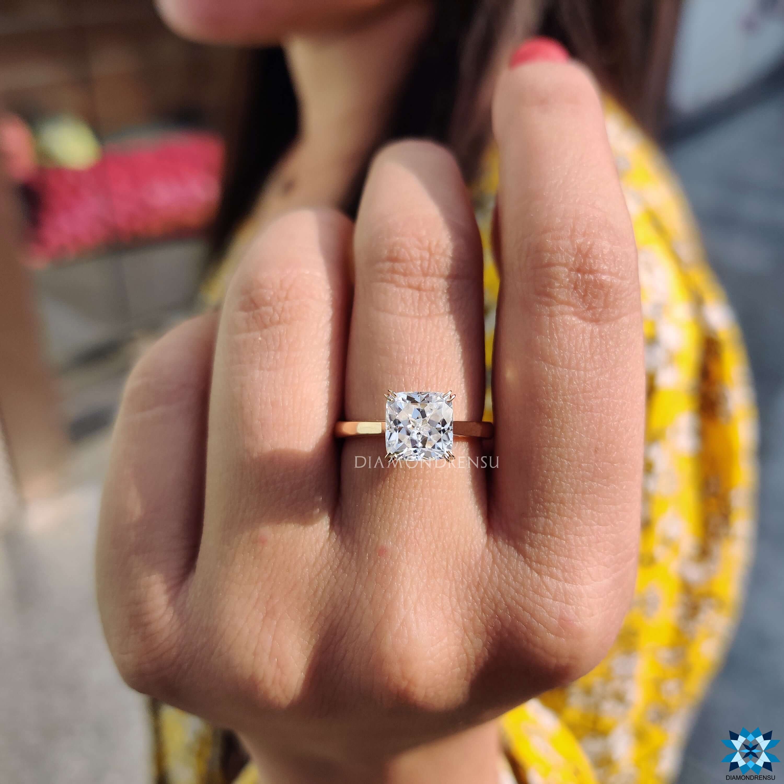 Solitaire engagement ring with cushion cut moissanite.