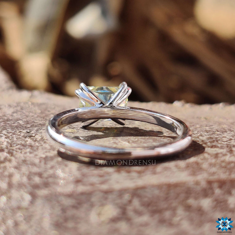 Double claw prong white gold moissanite ring.