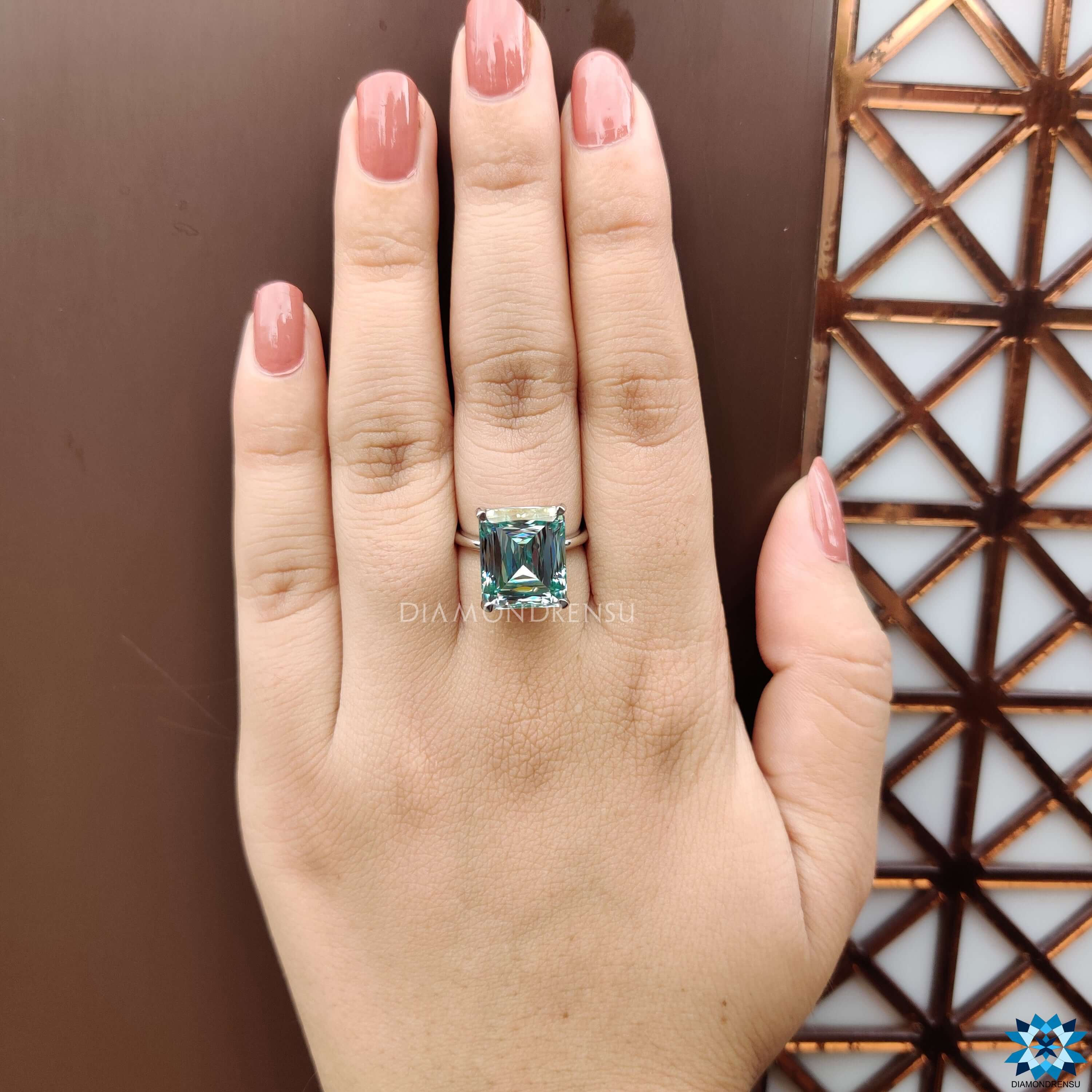 Moissanite engagement ring featuring criss cut cyan blue gemstone.