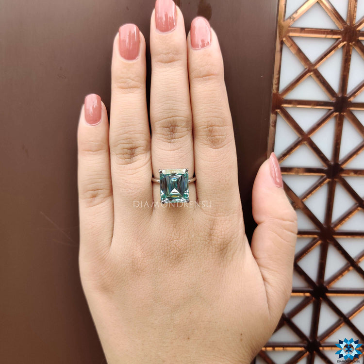 Moissanite engagement ring featuring criss cut cyan blue gemstone.