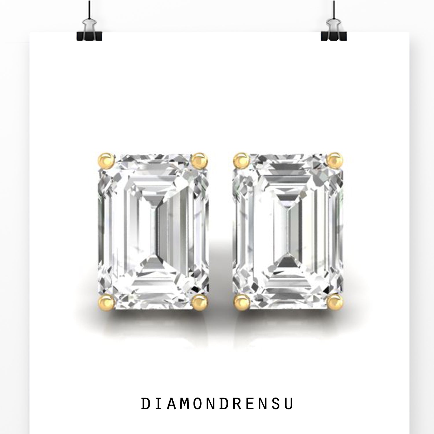 Gold diamond earrings with emerald cut stones and prong setting.